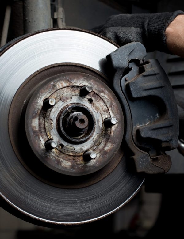 Car mechanic repair brake pads Closeup of car mechanic repairing brake pads